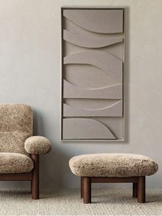 a chair and ottoman in front of a wall