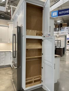 a kitchen pantry is shown in the middle of a room with white cabinets and drawers