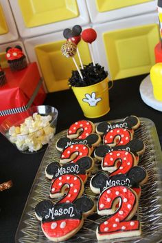 mickey mouse cookies and cupcakes on a table