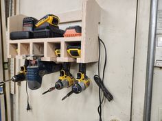 a workbench with drillers and tools hanging from it's hooks on the wall