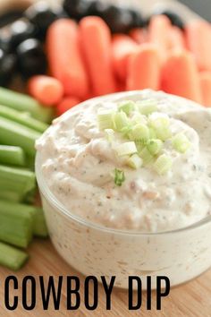 dip with celery and black olives on a cutting board