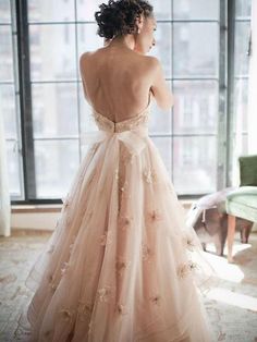 the back of a dress with flowers on it is shown in front of a window