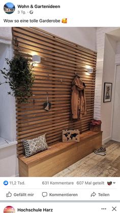 a wooden bench sitting in front of a wall mounted coat rack with lights on it