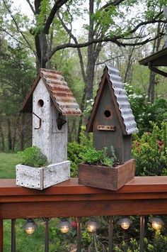 two bird houses are sitting on a deck