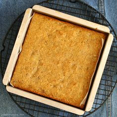 a square cake sitting on top of a cooling rack