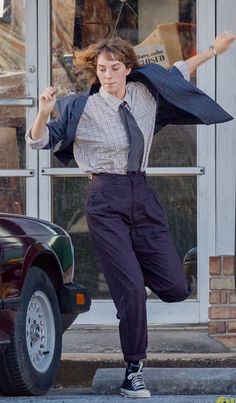 a man is jumping in front of a car