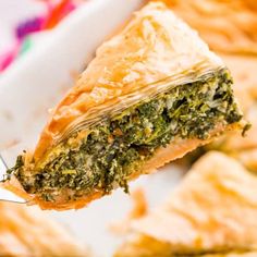 a piece of spinach pie being held by a fork