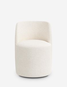 a white chair sitting on top of a white floor