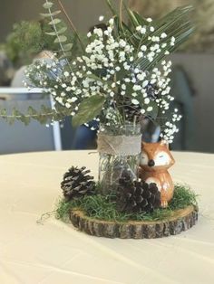 a vase filled with white flowers and baby's breath sitting on top of a table