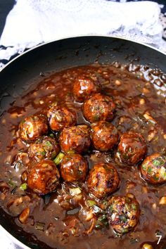 some meatballs are being cooked in a skillet