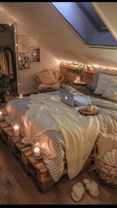 a bedroom with a bed made out of wooden pallets and lights on the ceiling