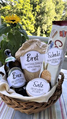 a basket filled with lots of different types of food and drinks on top of a table