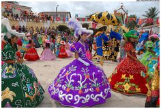 women in colorful dresses and headdresses at a festival