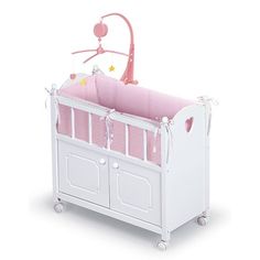 a baby crib with a pink and white bedding