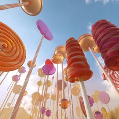 an array of colorful candy lollipops floating in the air on a sunny day