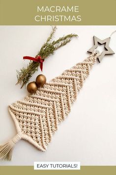 a crocheted christmas tree ornament hanging from a red ribbon on a white background