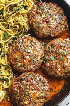 some meatballs and noodles are in a skillet