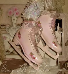 two pink ice skates with flowers on them