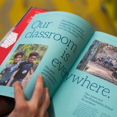 a person holding an open book with pictures on the cover and in front of them