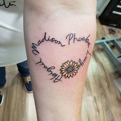 a person with a tattoo on their leg that says madison place and has a sunflower