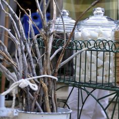 two large glass jars sitting on top of a metal rack filled with marshmallows