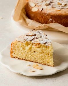 a piece of cake sitting on top of a white plate next to a paper bag