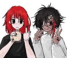 two people with red hair and black glasses are holding their fingers up in the air