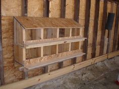 an unfinished room with wooden shelves and plywood