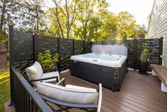 a hot tub sitting on top of a wooden deck