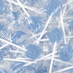 blue and white lollipops in plastic wrappers