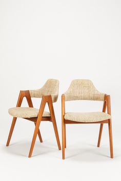 two chairs sitting side by side against a white background