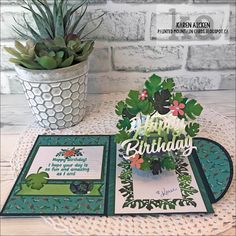 a card with some plants on it and a potted plant next to it that says happy birthday