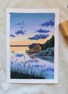 a watercolor painting of a house on the lake at sunset with clouds in the sky