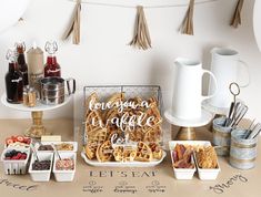 a table topped with lots of different types of food next to cups and saucers