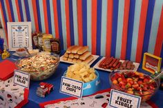 a table topped with lots of food next to a wall covered in striped paper towels