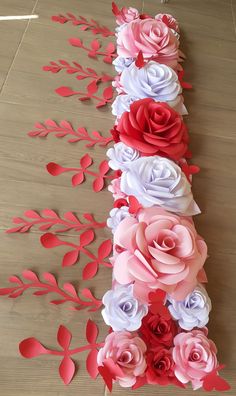 paper flowers and leaves are arranged on the floor