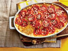 a casserole dish with tomatoes and cheese