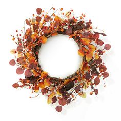 a wreath with autumn leaves and pine cones