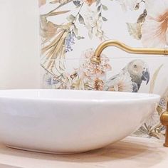 a white bowl sink sitting on top of a wooden counter