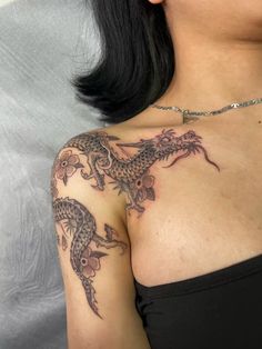 a woman with a dragon tattoo on her chest