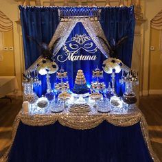 a blue and white dessert table with an elaborate sign on the top that says marinana