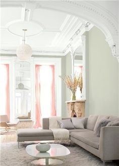 a living room filled with furniture and pink walls