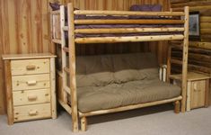 a bunk bed sitting next to a wooden dresser and chair in a room with wood paneled walls