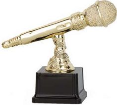 a golden microphone on top of a black stand