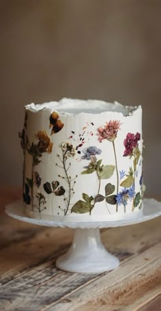 a white cake with flowers painted on it