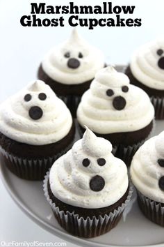 some cupcakes with white frosting and black eyes