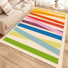 a multicolored rug on the floor in a living room with a couch and coffee table