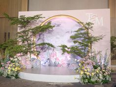 the stage is decorated with flowers and trees