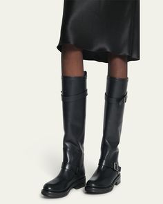 Saint Laurent "Biork" tall leather biker boots     1.00 in / 25 mm block heel    Round toe    Buckle straps at ankle and collar    Pullon style    Leather outsole    Made in Italy Leather Biker Boots, Biker Boots, Leather Buckle, Black Boots, Block Heels, Saint Laurent, Tops Designs, Top Brands, In Italy