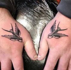 two people with matching tattoos on their hands